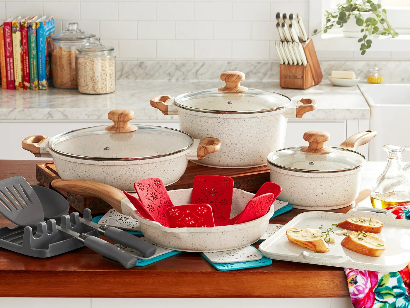 Pioneer Woman linen cast aluminum cookware set on a farmhouse counter